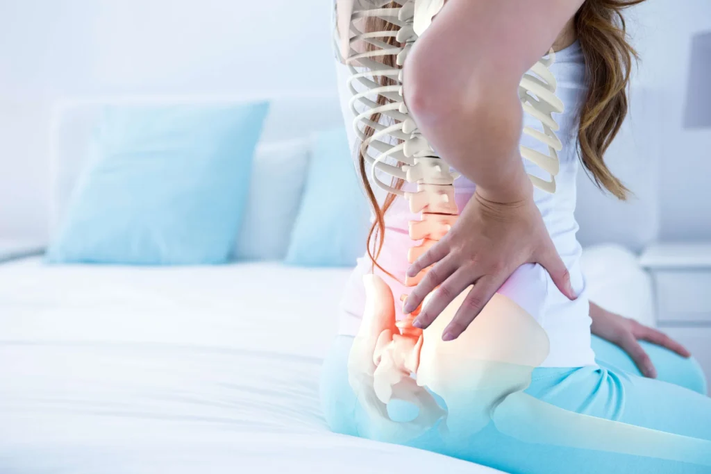woman holding lower back in pain on bed 2026 03 26 11 49 34 utc RTYugm1Xv0AgmMVXEeHiwbzlZst5lx